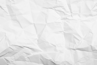 Photo of Sheet of white crumpled paper as background, closeup