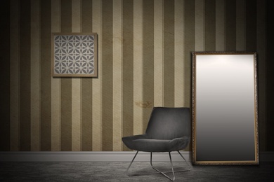 Image of Chair, mirror near wall with picture and patterned wallpaper. Stylish room interior