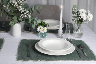 Photo of Elegant festive setting with floral decor on table