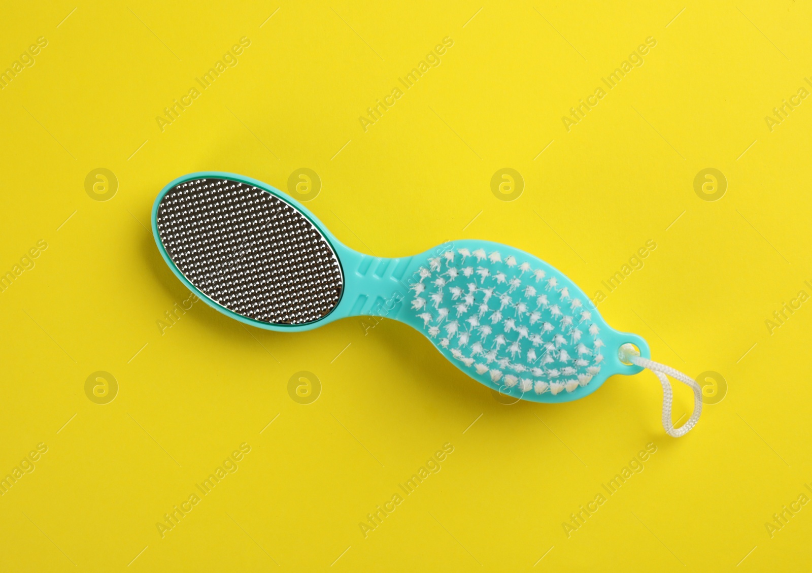 Photo of Pedicure tool with metal foot file and brush on color background, top view