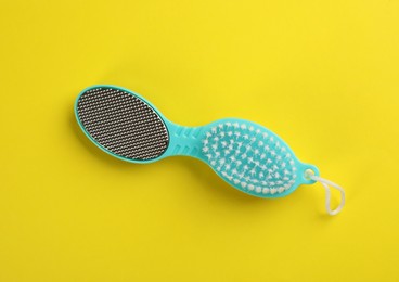 Photo of Pedicure tool with metal foot file and brush on color background, top view