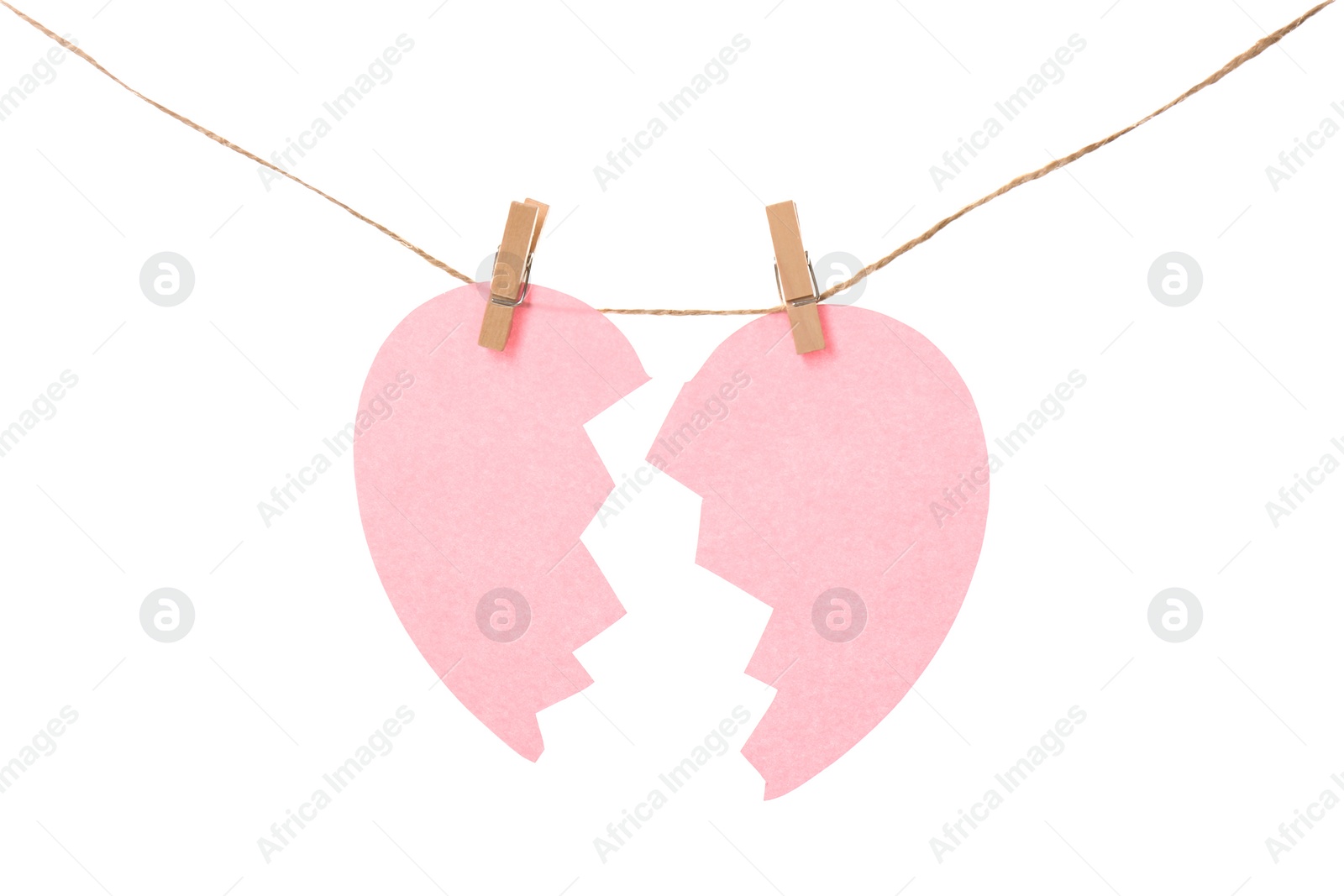 Photo of Halves of paper heart hanging on rope against white background. Relationship problems