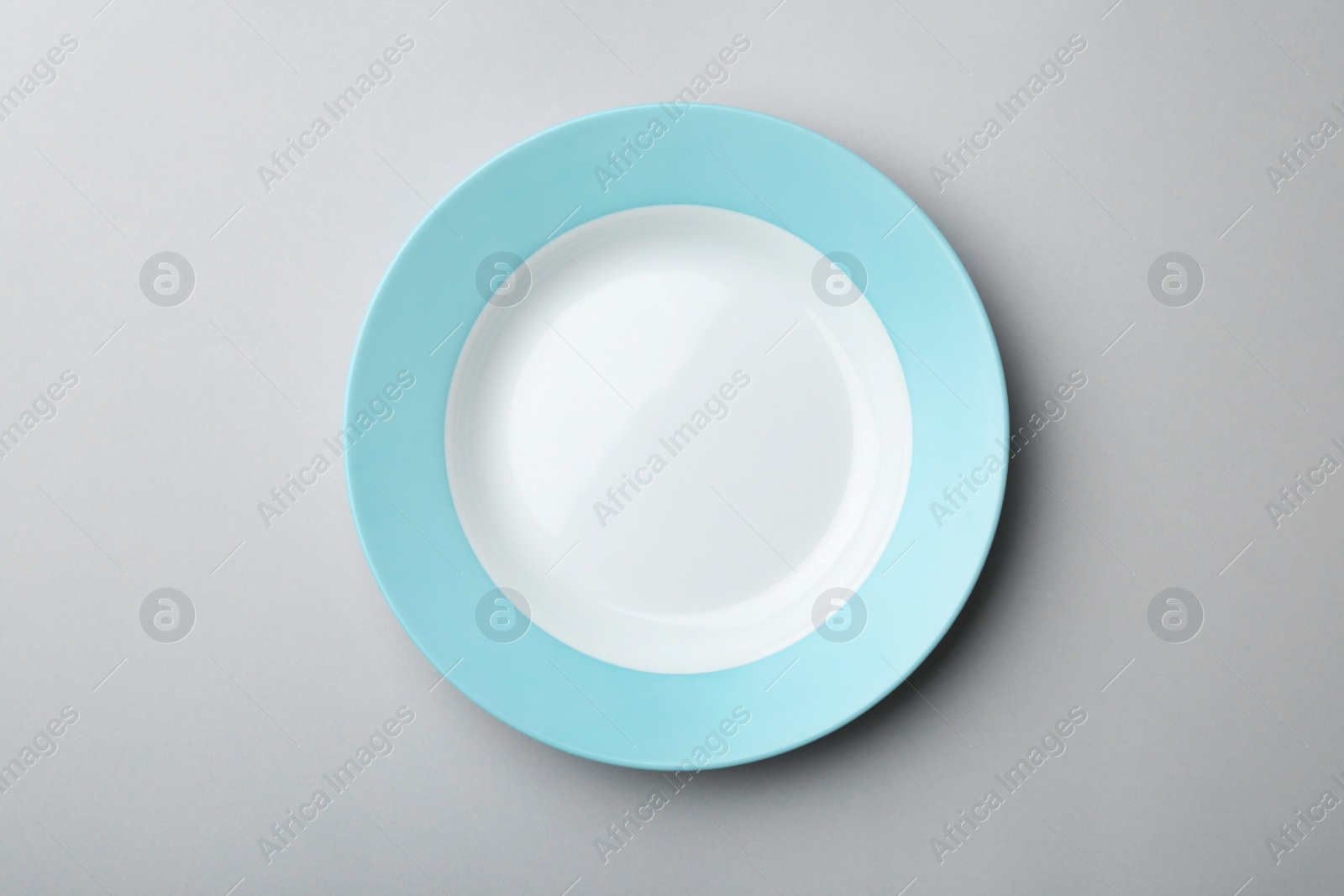 Photo of Clean empty plate on grey background, top view