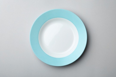 Clean empty plate on grey background, top view