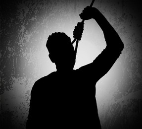 Image of Silhouette of depressed man with rope noose on neck. Suicide concept 