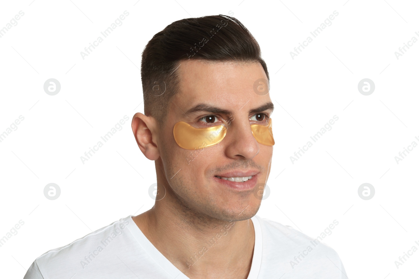 Photo of Man with golden under eye patches on white background