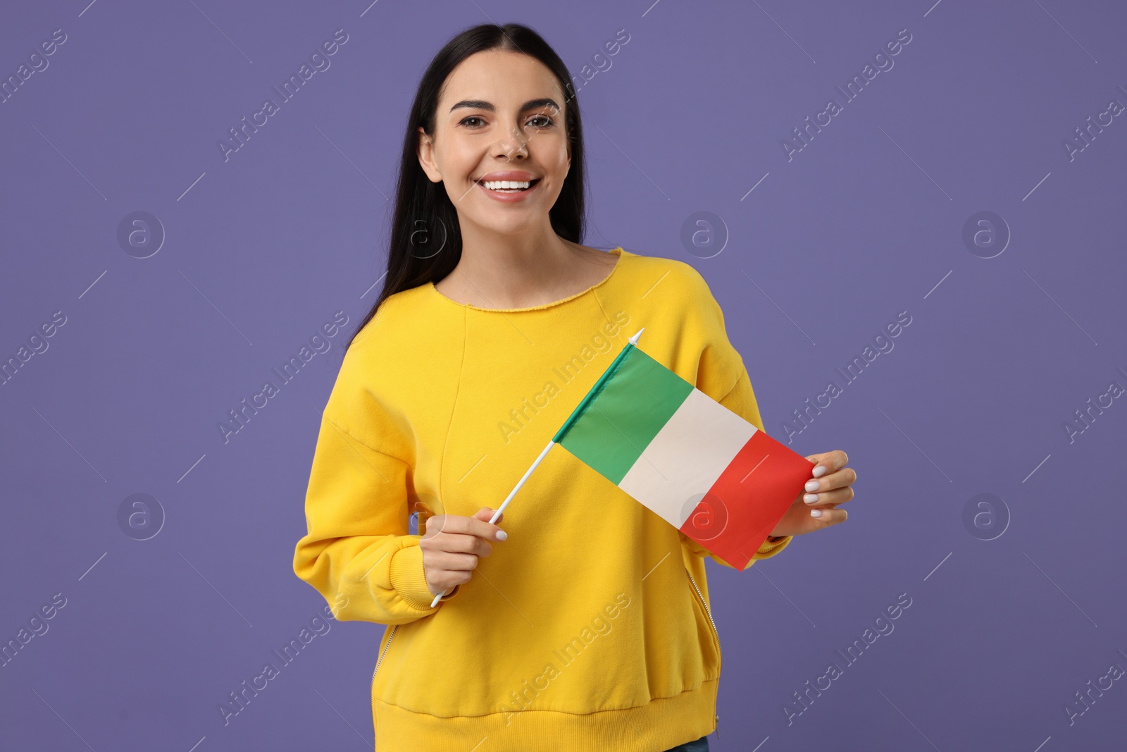 Photo of Happy young woman with flag of Italy on violet background