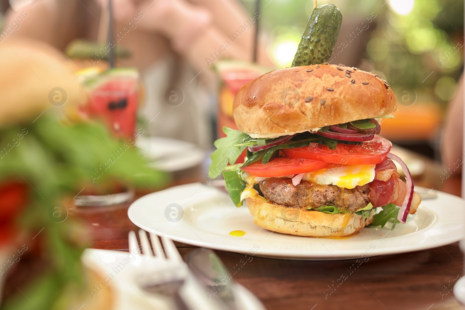 Photo of Plate with tasty fresh burger on table