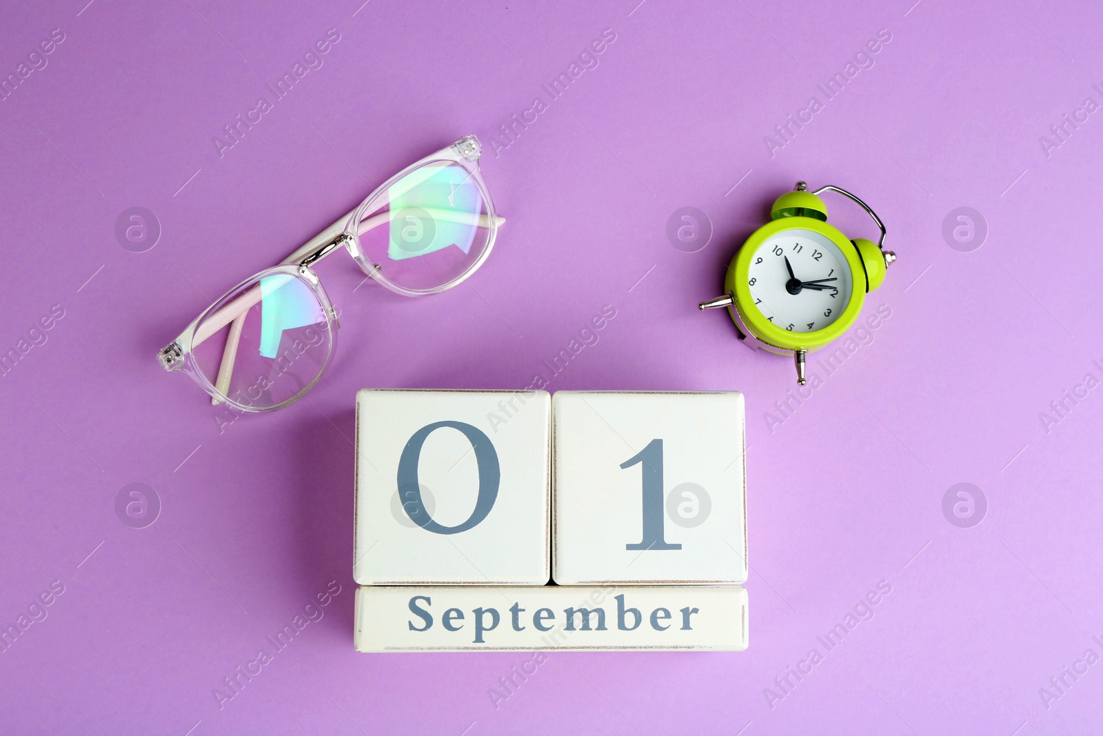 Photo of Calendar, glasses and alarm clock on violet background, flat lay