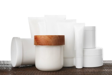 Photo of Set of different creams on wooden table against white background