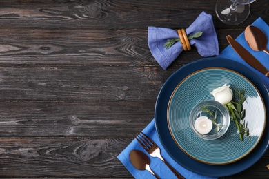 Photo of Elegant festive table setting on black wooden background, flat lay. Space for text