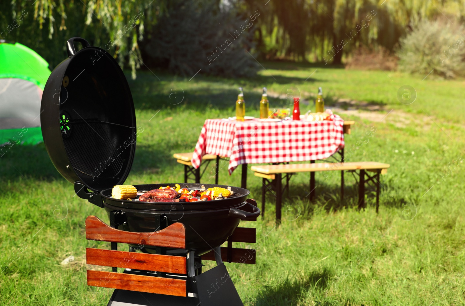 Photo of Modern barbecue grill with tasty food in park