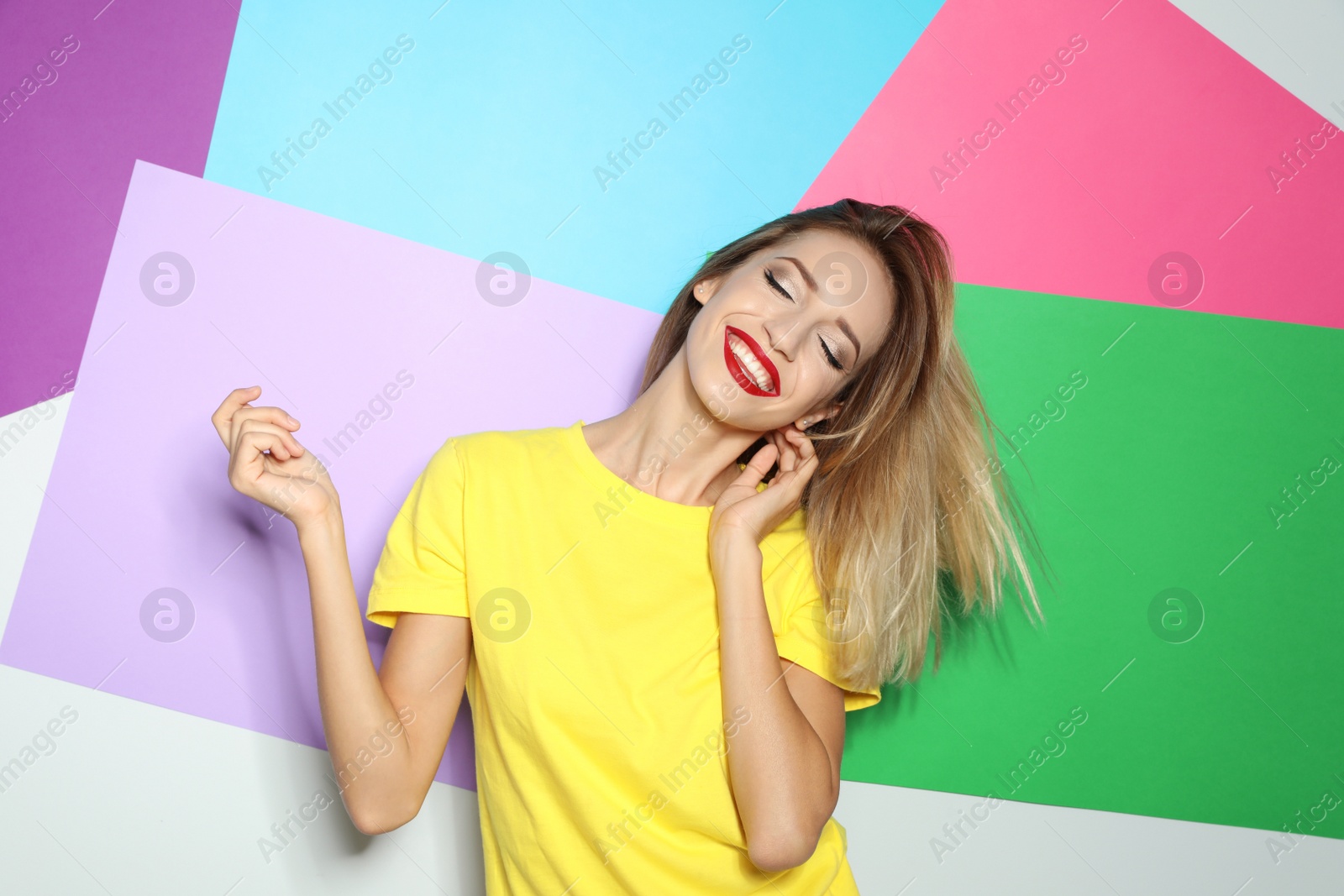 Photo of Beautiful young woman with healthy long blonde hair on color background