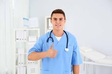 Photo of Young medical assistant with stethoscope in clinic