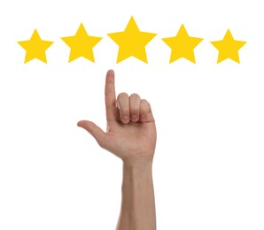 Image of Quality evaluation. Man pointing at golden star on white background, closeup