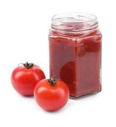 Photo of Organic ketchup in glass jar and fresh tomatoes isolated on white. Tomato sauce