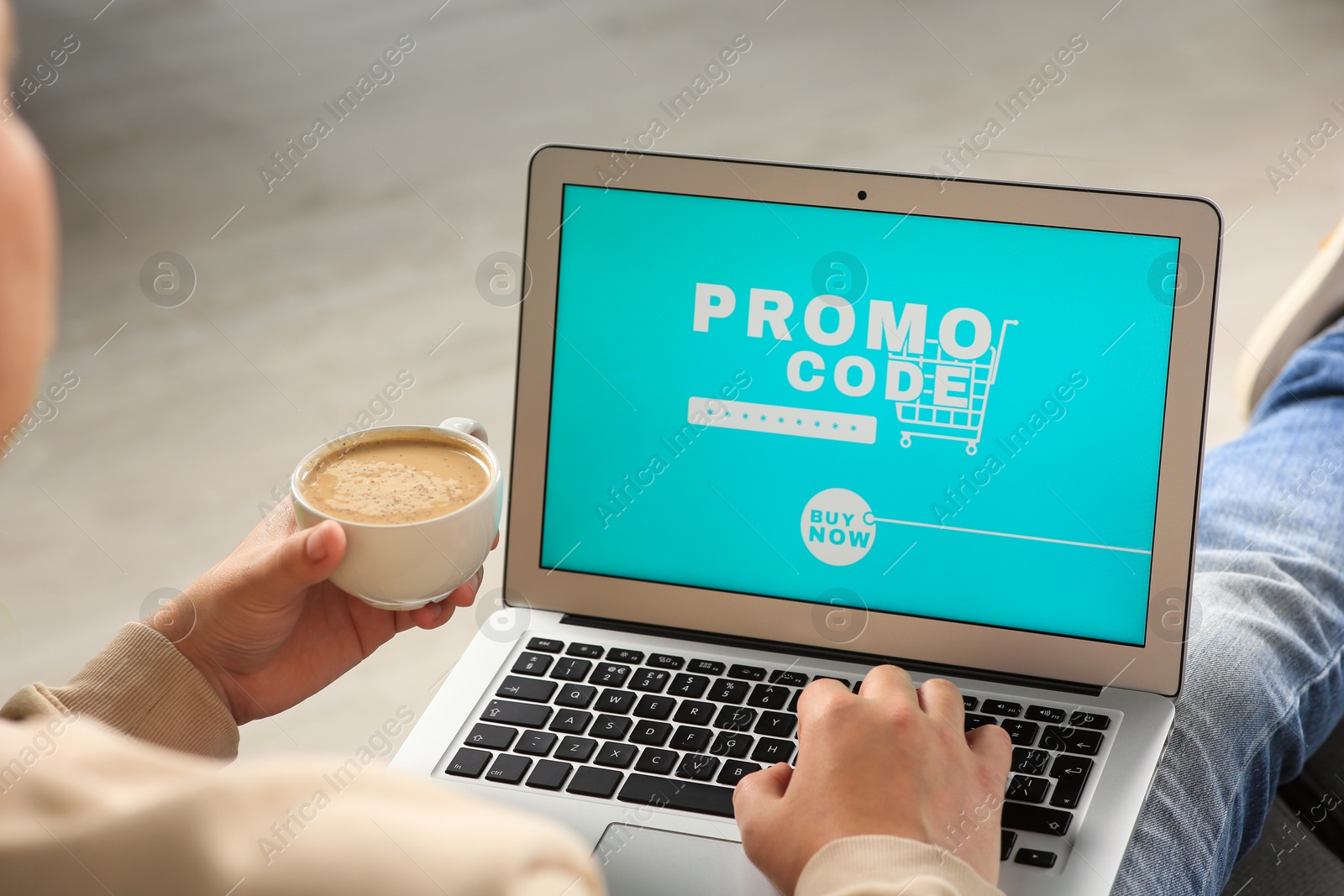 Photo of Man with laptop activating promo code while doing online shopping indoors, closeup