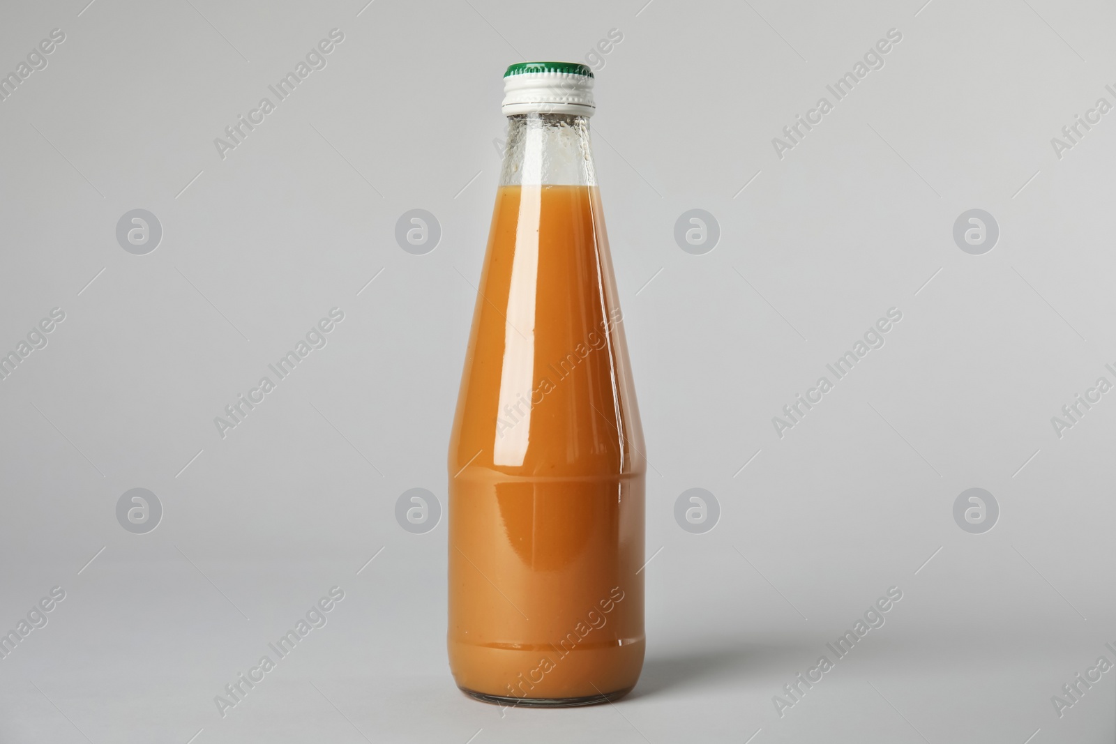 Photo of One bottle with tasty drink on color background