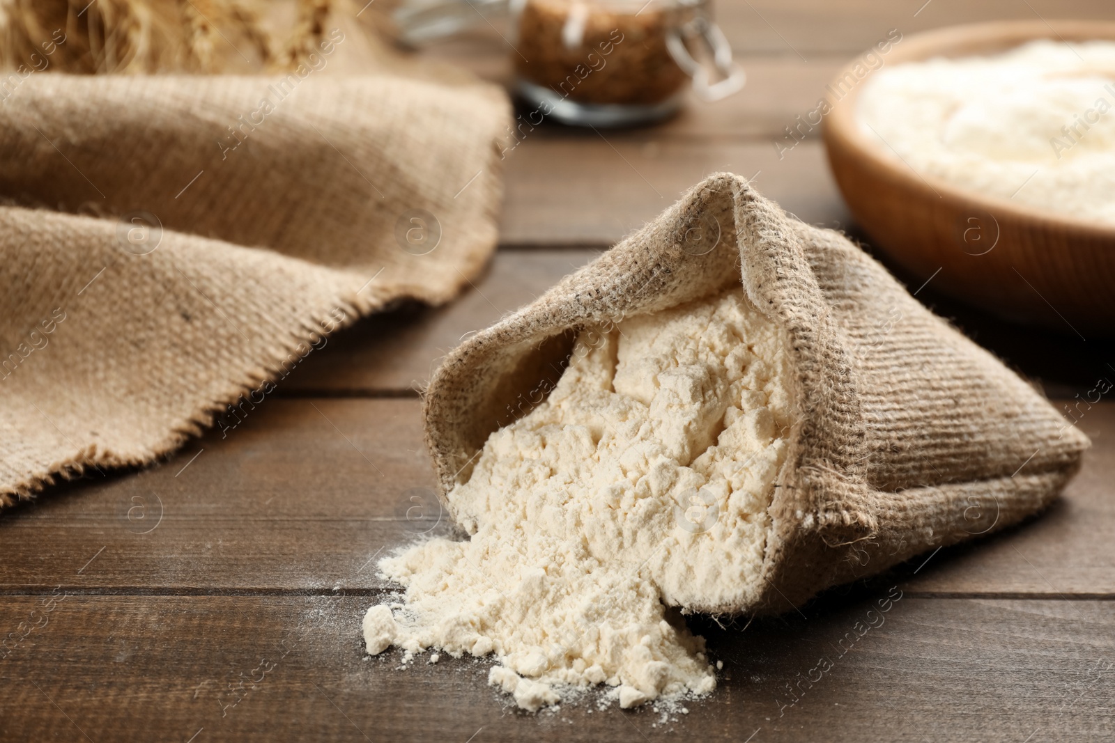 Photo of Overturned sack of flour on wooden table