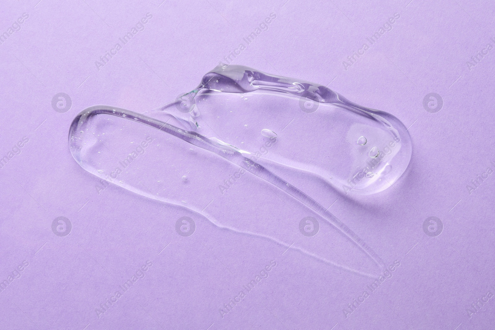 Photo of Clear cosmetic gel on violet background, top view