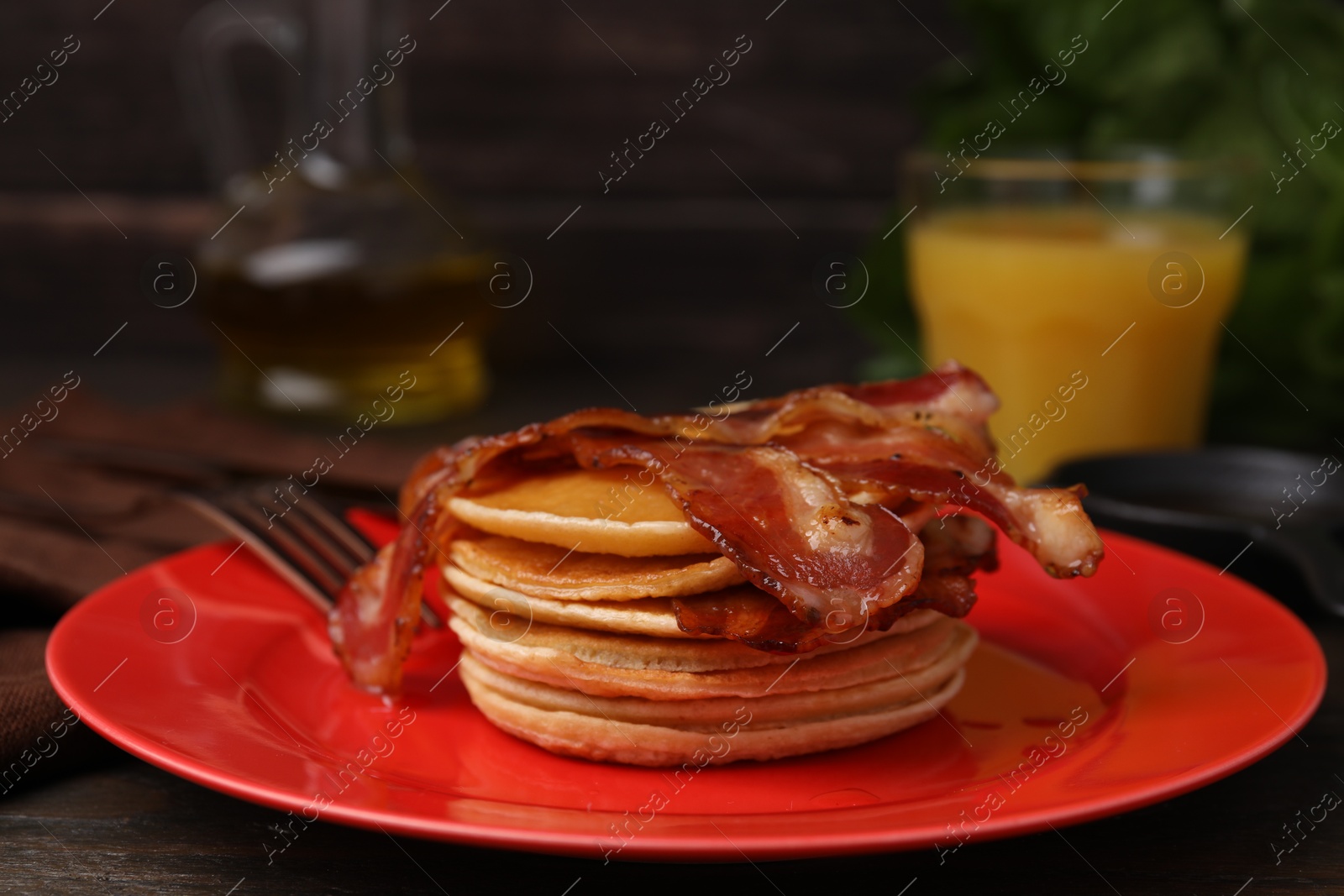 Photo of Delicious pancakes with bacon on table, closeup