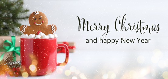 Merry Christmas and Happy New Year. Gingerbread man in red cup with marshmallows on white table, banner design