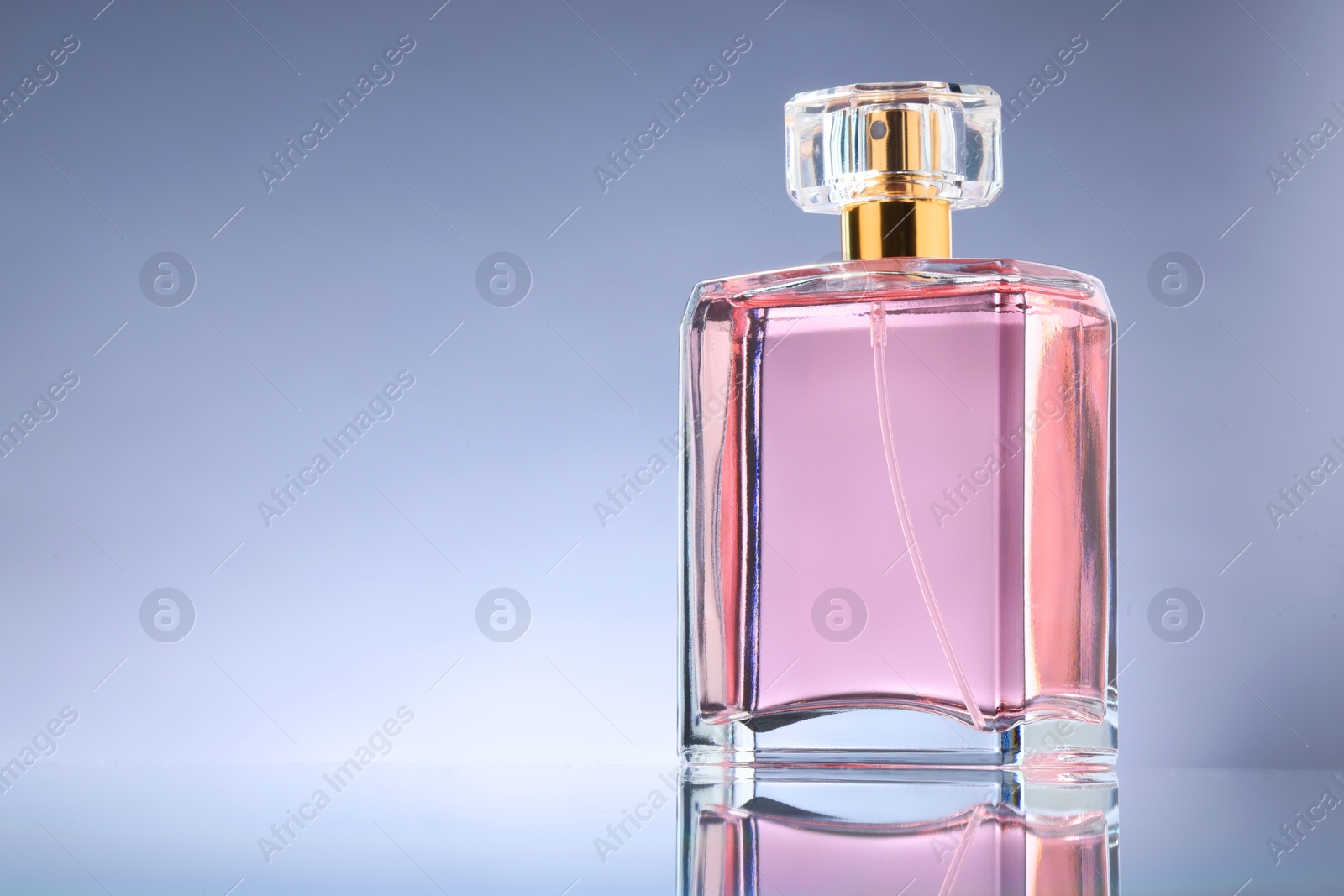 Photo of Luxury women's perfume in bottle on grey background. Space for text