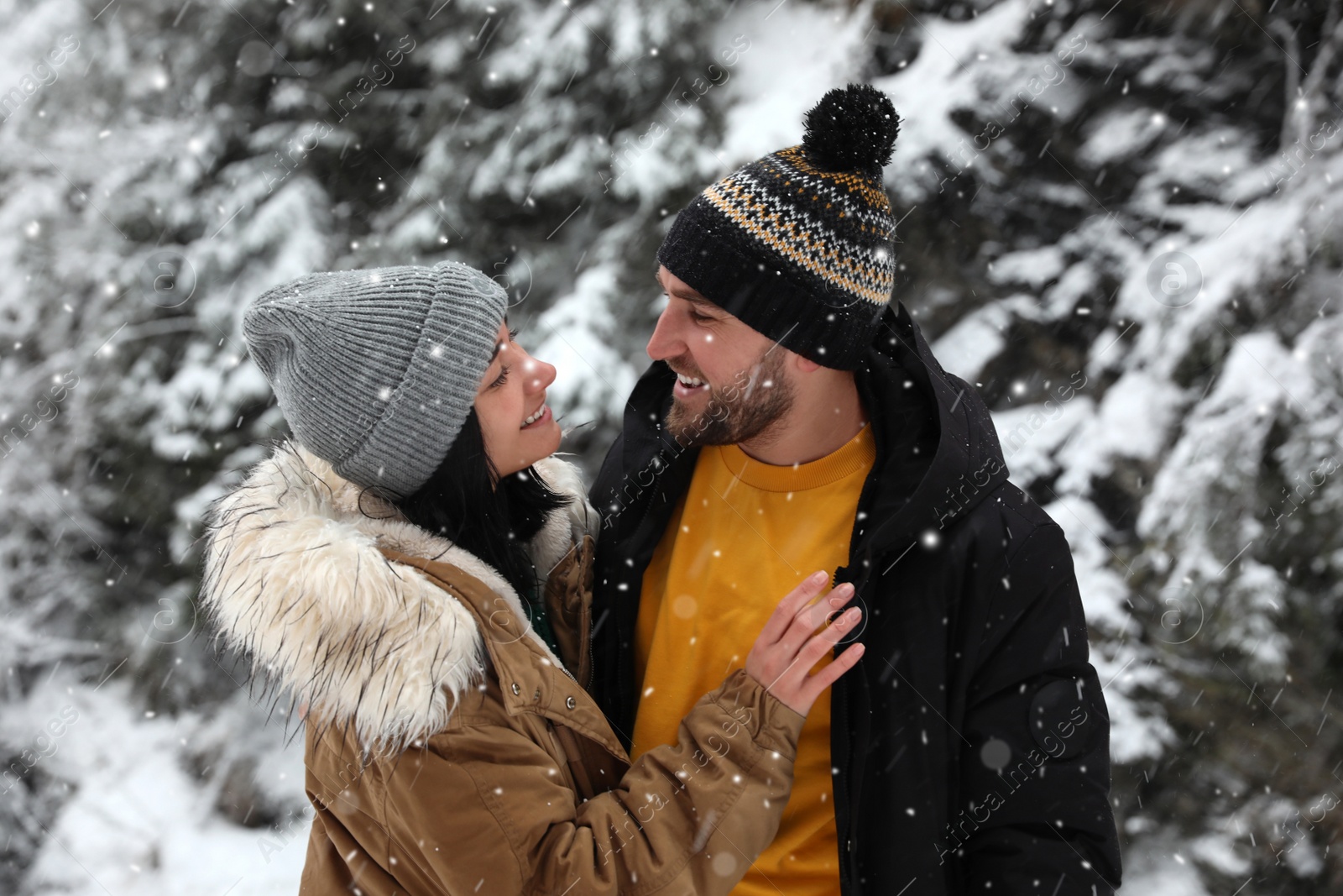 Photo of Lovely couple outdoors on snowy day. Winter vacation