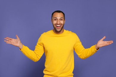 Photo of Portrait of happy African American man on purple background