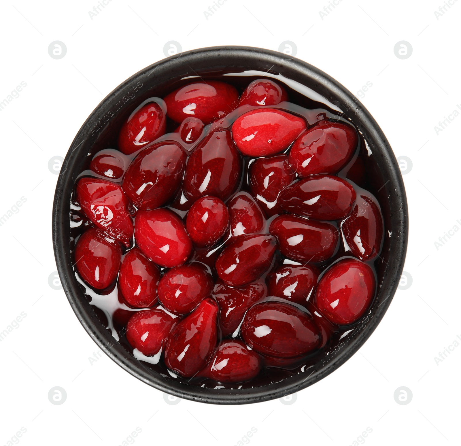 Photo of Delicious dogwood jam with berries in bowl isolated on white, top view