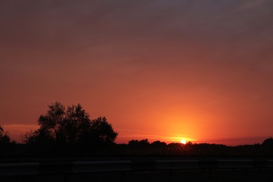 View of asphalt road without transport at sunset