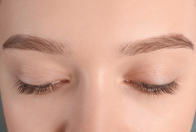 Photo of Young woman with beautiful natural eyelashes, closeup