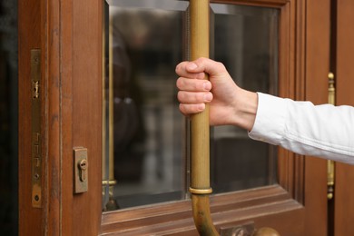 Photo of Butler opening hotel door, closeup of hand