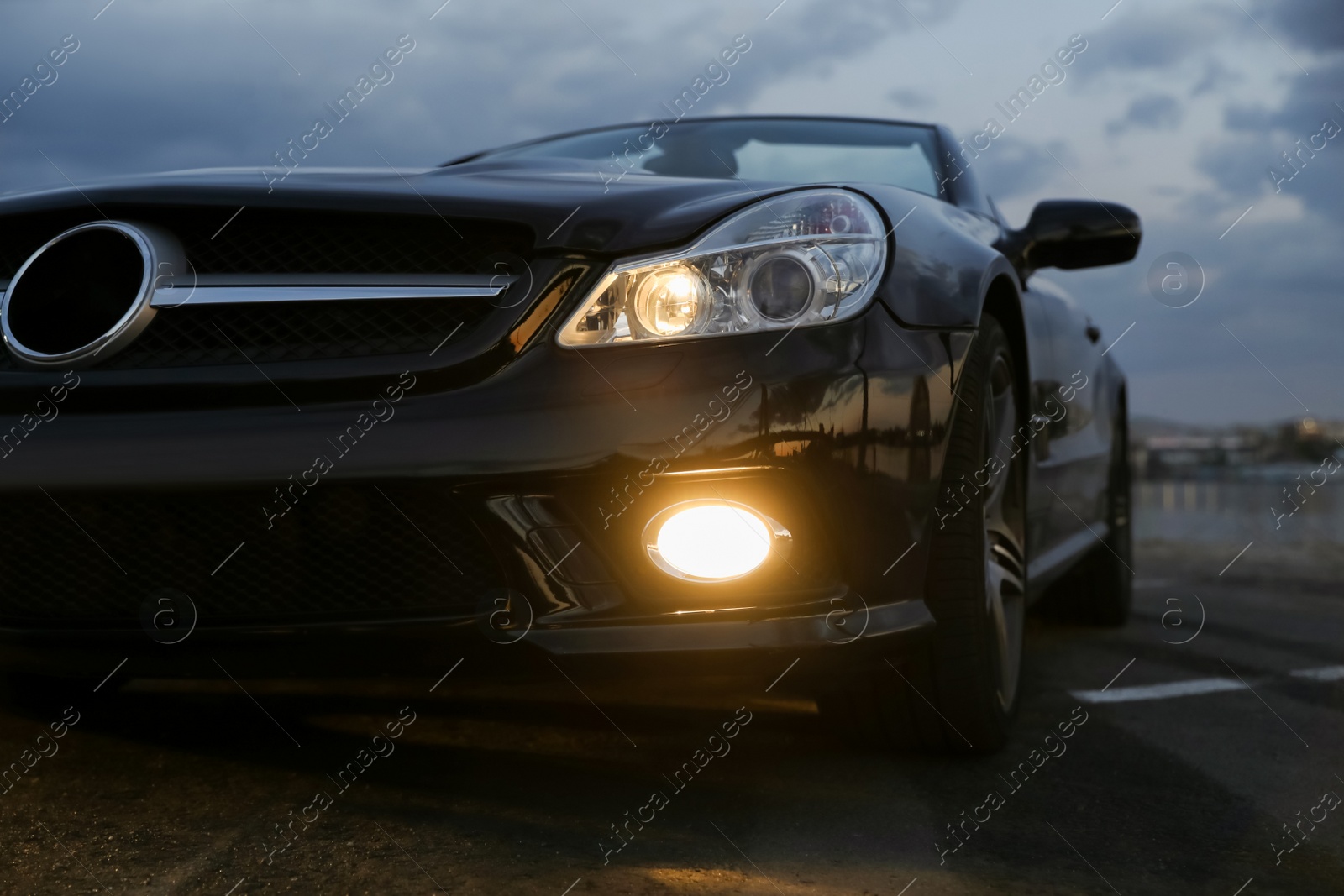 Photo of Luxury black convertible car outdoors in evening, closeup