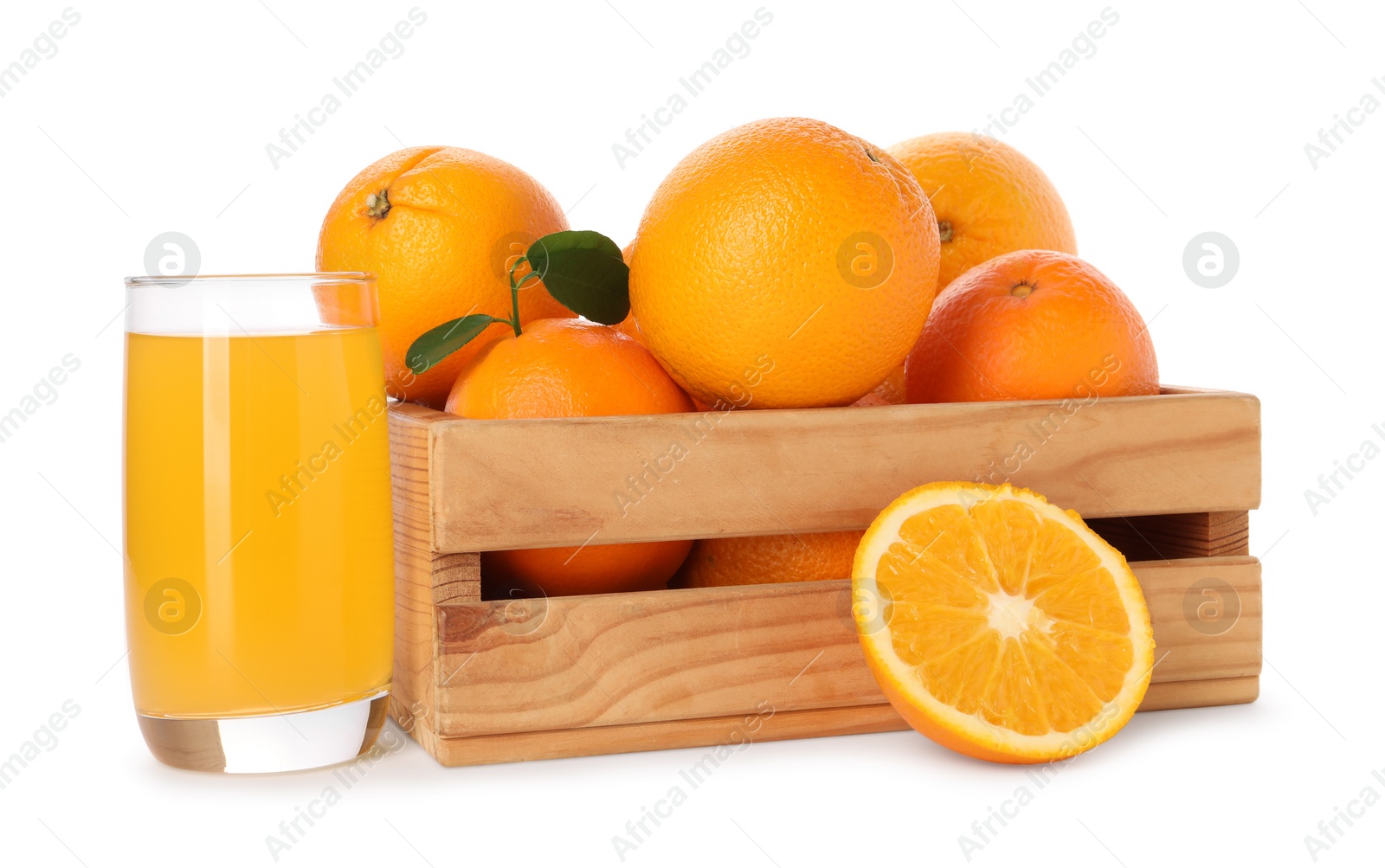 Photo of Fresh oranges in wooden crate and glass of juice isolated on white