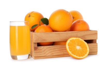 Fresh oranges in wooden crate and glass of juice isolated on white