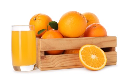 Photo of Fresh oranges in wooden crate and glass of juice isolated on white