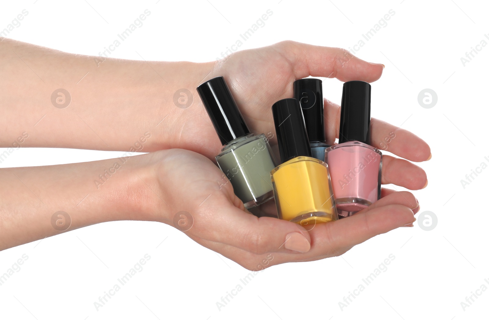 Photo of Woman holding nail polishes on white background, closeup