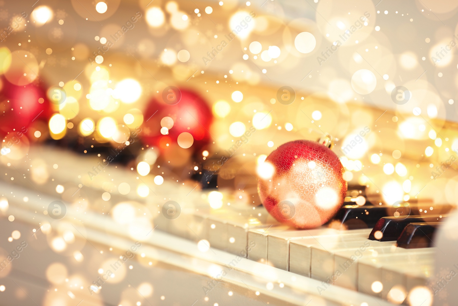 Image of Christmas and New Year music. Piano with festive balls, bokeh effect