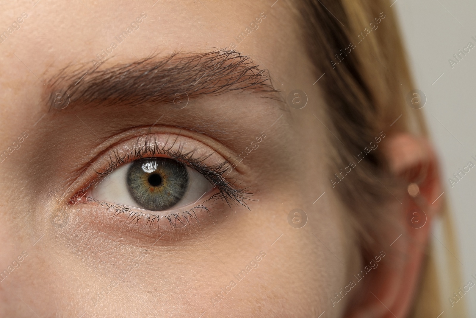 Photo of Beautiful woman with grey eye, closeup view