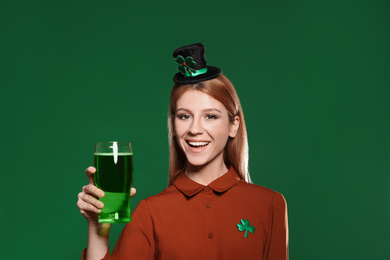 Photo of Young woman with green beer on color background. St. Patrick's Day celebration