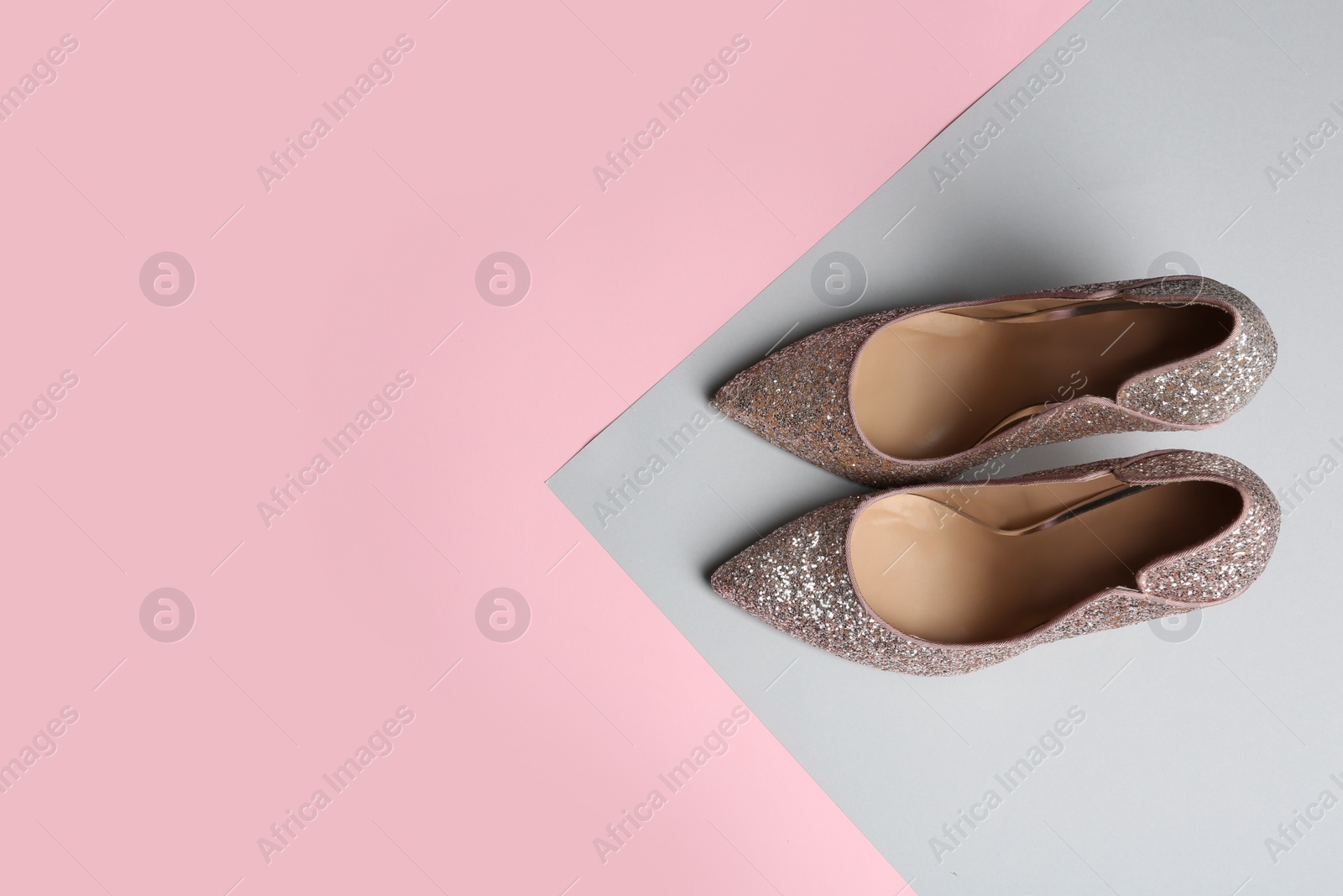 Photo of Stylish high heel shoes on color background, top view. Space for text