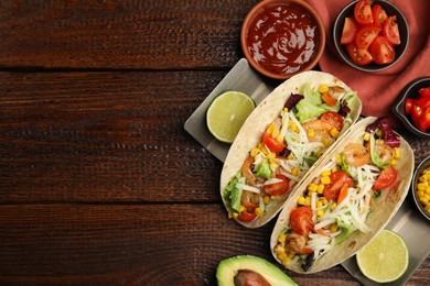 Delicious tacos with shrimps and cheese served on wooden table, flat lay. Space for text