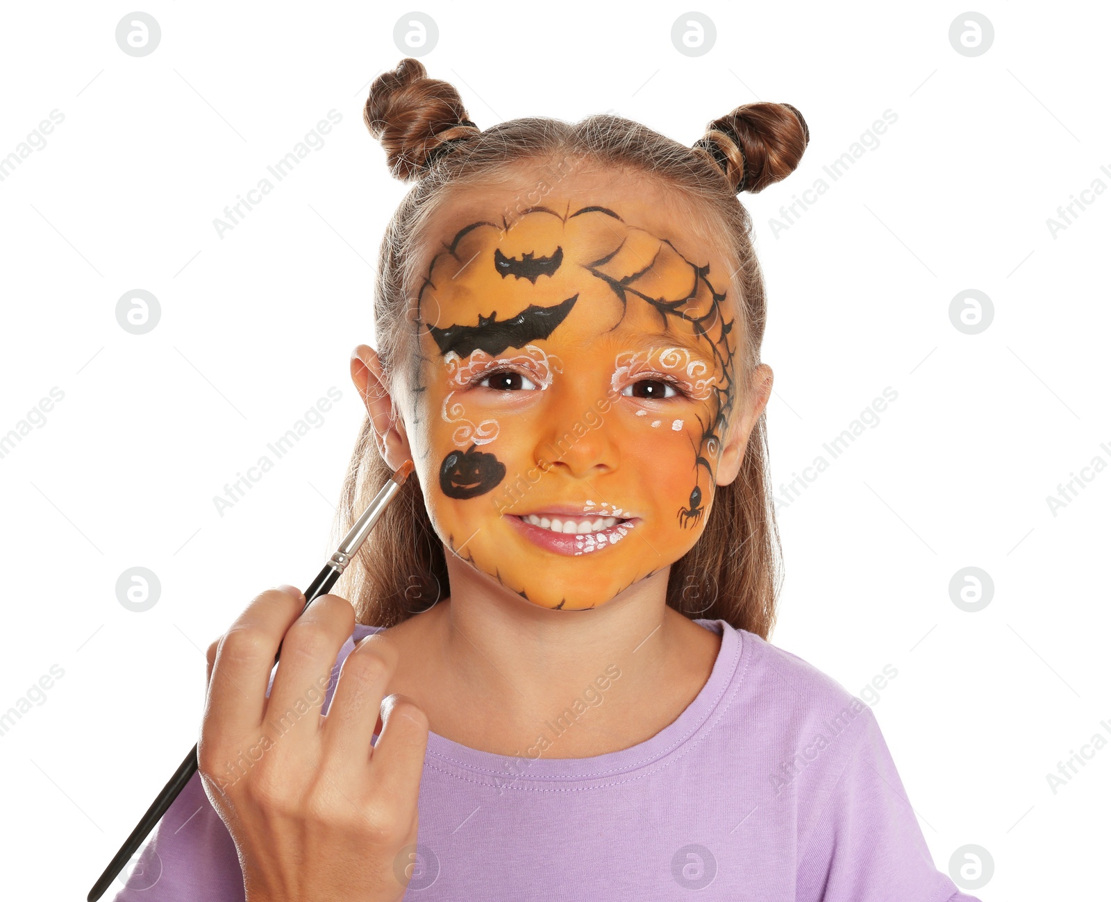 Photo of Artist painting face of little girl on white background