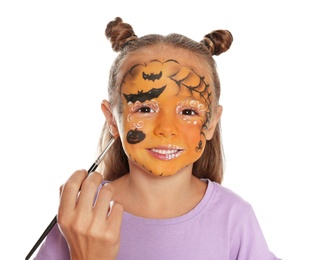 Photo of Artist painting face of little girl on white background