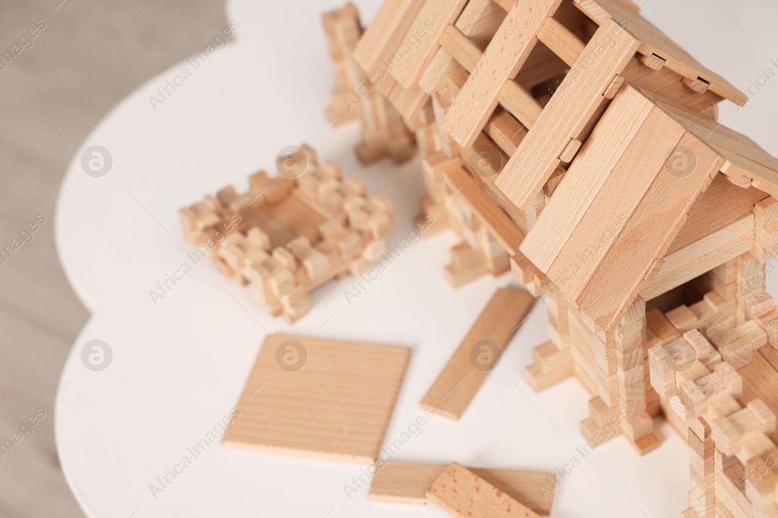 Photo of Wooden entry gate and building blocks on white table indoors, space for text. Children's toy