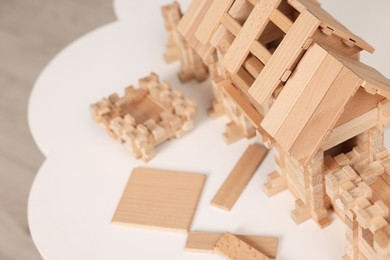 Photo of Wooden entry gate and building blocks on white table indoors, space for text. Children's toy