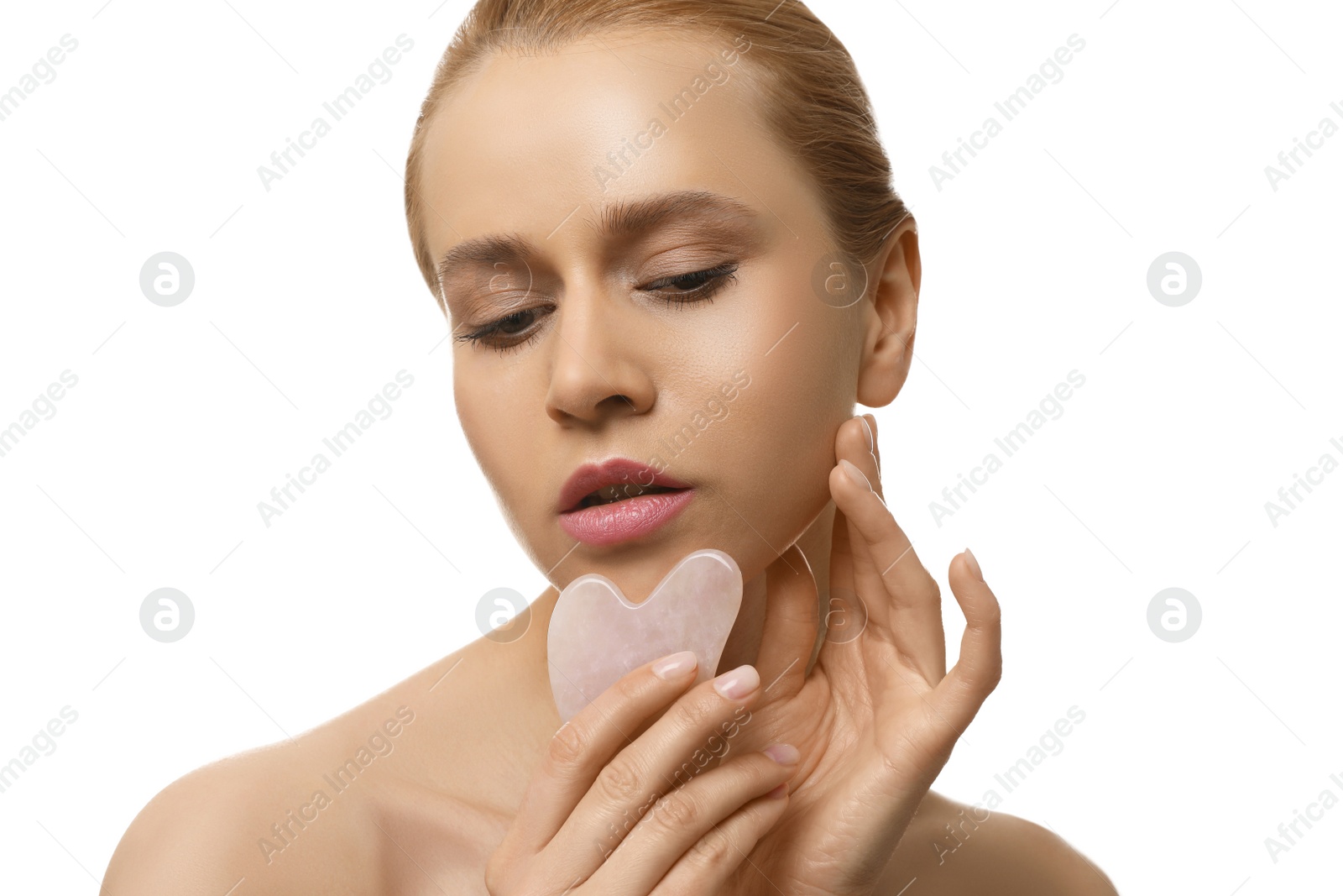 Photo of Beautiful young woman doing facial massage with gua sha tool on white background, closeup