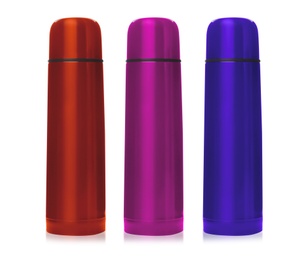 Image of Set of modern thermoses in different colors on white background 