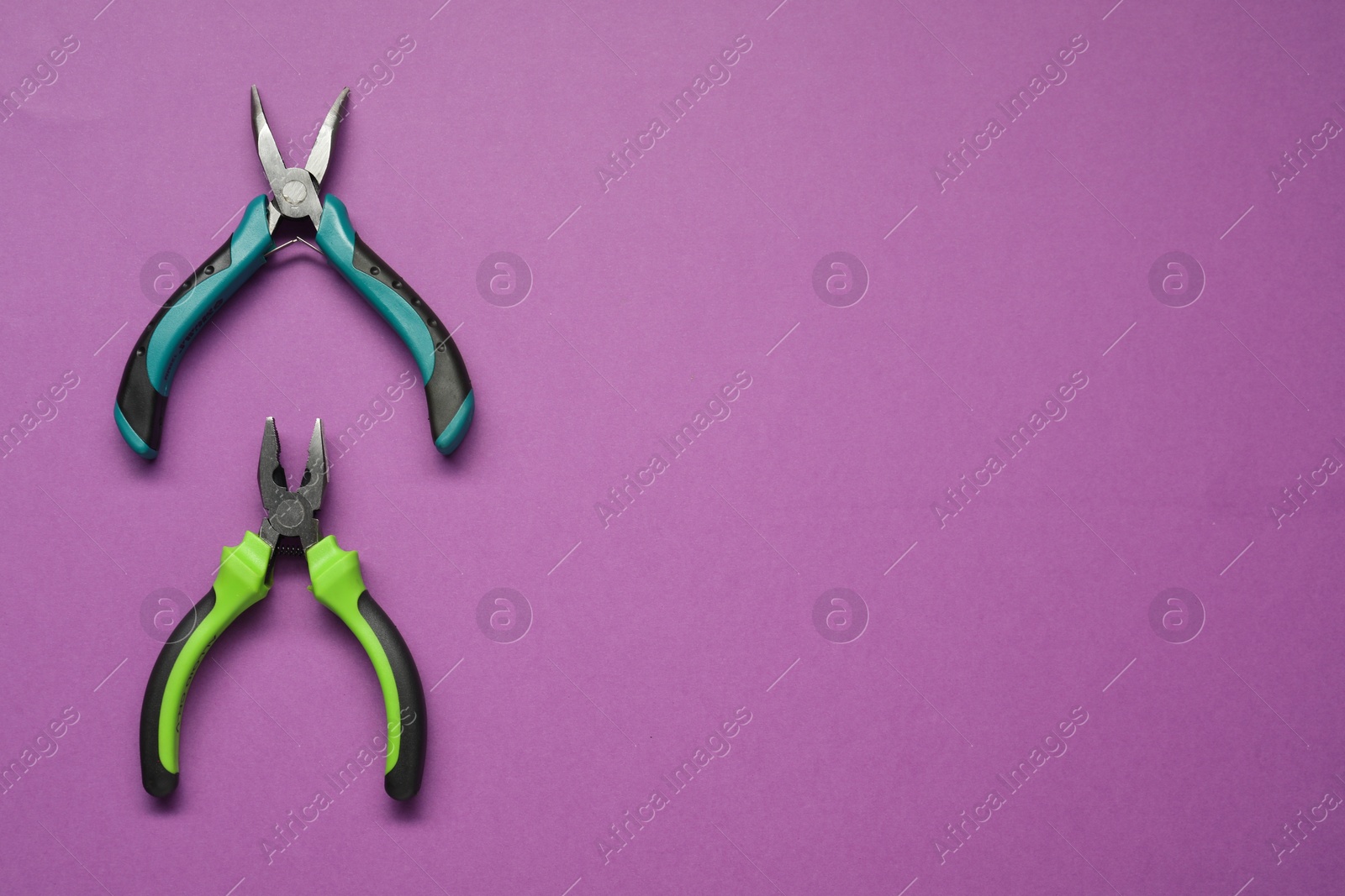 Photo of Pliers on purple background, flat lay. Space for text